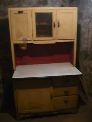 Antique Hoosier Cabinet. Unknown manufacture, unknown year, unknown wood use. on door has crack, warping on sideboards,...