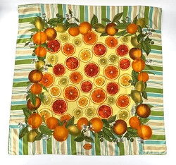 Circa 1970s, this amazing Gucci Silk scarf features a blue, green and white stripe trim with a colorful citrus motif in...