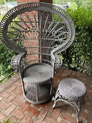 This vintage peacock chair and stool set is a unique addition to any boho or mid-century modern space. The ornate...