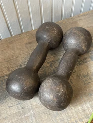 Antique cast iron dumbbells in a great 9 lb size. Classic spherical ends with less common fat contoured handles....