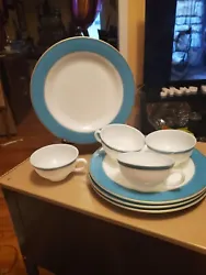 Vintage pyrex with a wide turqouise band and a small gold band. The set includes 4 dinner plates and four coffee cups....