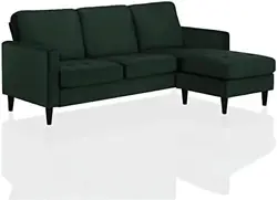 Covered in lush green velvet upholstery, the sofa is perched on sleek contrasting black wooden legs for durability....