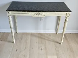 Console table measures 41 inches long,  24 inches wide, and 39 inches high.   The table features a floral design and...