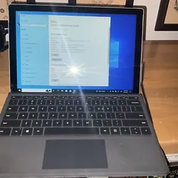 Slightly cracked in the bottom left corner, other than that works great with charger and keyboard, reset windows 10 pro...