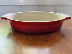 Le Creuset Stoneware Oval Red Handled Baking Dish 12.5” X 8.5”. Very good used condition. No chips, cracks or...