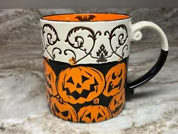 Large coffee mug by Eli & Ana Handmade Ceramics. Orange jack o lanterns with swirls on the outside. Orange on the...