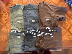 Olive green, brown and gray scrubs with one pocket on front of top and two back pockets on pants. Stitching is white....