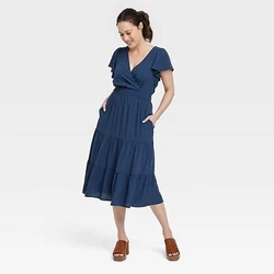 •Tiered A-line midi dress •Made of breathable and flowy fabric •V-neckline with wrap accent •Short flutter...