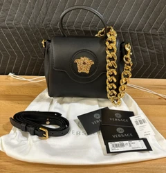 This Versace handbag is real and has been authenticated by Versaces authenticity program. Leather shoulder strap. Size:...
