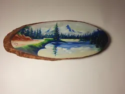 This is a unique hand-painted mountain scene on a beautiful burl wood knot. The artwork showcases a stunning landscape...