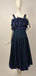 FASHIONED OF DENIM AND PURPLE COTTON WITH ZIP IN THE REAR. A VERY UNUSUAL 1980’S DRESS. Often for proper fit, hang,...