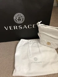 Versace White Bucket Bag. 100% Authentic. Purchased at the Versace store. New with tags, comes with dust bag and box it...