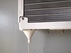 This is a 3D printed adapter that magnetizes to your window unit air conditioner and drains through the clear drain...