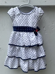This Jona Michelle dress is a charming addition to any girls wardrobe. Featuring a playful polka dot pattern in blue...