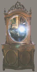 Late Victorian English two part mirrored cabinet.Circa 1870. Very decorative, light honey-colored walnut with lots of...