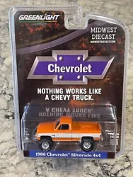 This is a Greenlight Midwest Diecast Exclusive Orange and White 1986 Chevrolet Silverado 4 x 4 Limited Edi tion diecast...