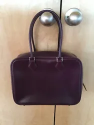 Made of smooth leather - the color is a RAISIN -- looks purple in the light - see picture. GREAT contrast RASPBERRY...