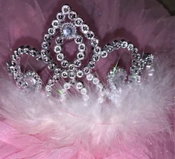Attached Stay-Put combs. This tiara screams fun. Estimated age range is 3-8, very flexible.