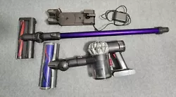 Dyson V6 Cordless Stick Vacuum Cleaner with hardwood floor brush attachment, carpet attachelment, and charger.  In...