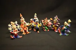 The clowns in the back are made of what looks like a clay one is missing the legs.