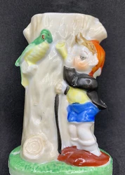 Vintage 1950s Ceramic Tree Trunk Bud Vase with Boy Playing Horn and Bird made in Japan. Measures approximately 4 inches...