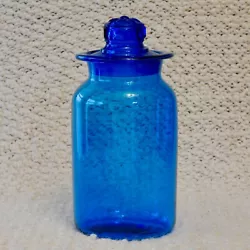 You are looking at a Beautiful Blue Glass Apothecary Jar/Canister with a Ground Glass Daisy Pattern Lid. The jar...