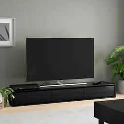 Our extra wide, floor-hugging TV stand exudes modernity with its minimalist silhouette and sleek black finish. 65