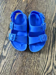 Blue little kids Birkenstock sandals with heel strap. 