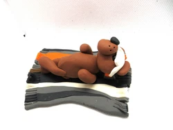 This bear is so cool with his sunglasses as he sunbathes.