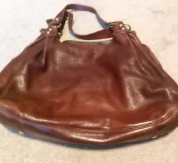Beautiful vintage brown leather hobo style with purple lining; there are many compartments with zippers and snaps;...