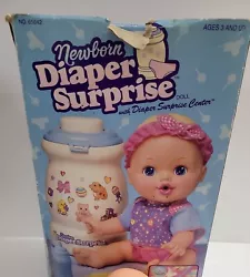 PLEASE READ:BOX HAS WEAR BUT DOLL IS NEW .(Please see pictures) Newborn Diaper Surprise Center Baby Doll Toy Open Box...