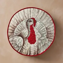Made from canvas fabric with filling, this round pillow features a textured print of a turkey with a red border and...