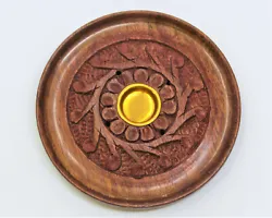 A round incense burner made of wood with decorative carving. Can burn incense sticks standing up, and cones on the...