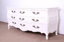 By John Widdicomb. An exceptional French Provincial Louis XV style nine-drawer dresser or credenza. White lacquered...