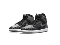 The Air Jordan 1 High OG Rebellionaire unveils a black leather structure with grey leather accents on the collar, toe...