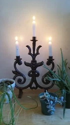 The candelabra has a Victorian Antique look. But I am not sure of its true age. I believe its a modern reproduction....