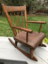 This is an incredibly Rare brown wood Antique Childs Windsor Rocking Chair, made probably in the mid 19th century, by...