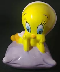 This adorable ceramic coin piggy bank features the beloved cartoon character Tweety Bird from the classic Looney Tunes...