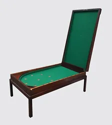 The players stand at the squared edge and use the cue stick to hit balls toward the 9 scored pockets. This table was...