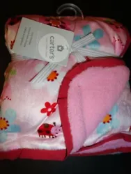 Pink velour blanket with an allover ladybug and floral print. The reverse side is pink sherpa. 100% polyester.