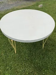 Retro Formica round kitchen table Yellow wrought iron legs. Top has some stains. Some paint chipping in the legs but...