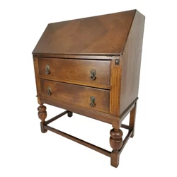 Antique Drop Front Secretary Desk. It has large round, turned wood legs, fluting on the sides of the drawers, and...