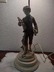 Beautiful vintage lamp. Boy holding a birds nest. Lamp is in overall great condition. Needs a little dusting. It works....