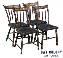 The chairs are mostly black with gold ringlet turnings and red and green stenciling along the seat & stretchers....