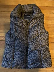 The short, sleeveless jacket is made from high-quality polyester and features a chic black animal print pattern. The...