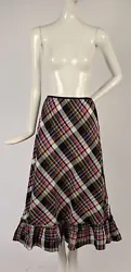 FASHIONED OF TAFFETA WITH A BRIGHT PLAID PRINT. THE BOTTOM IS IN A RUFFLE, THE WAISTBAND AT THE TOP IS ELASTIC. DATING...