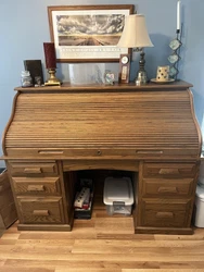 Solid wood rolltop desk with many compartments, drawers, cubbies. Rolling wood chair included. Rolltop desk 61 wide by...
