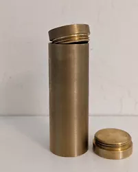 Finely-machined brass canister.