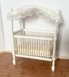 A cute canopy crib for your miniature nursey. 