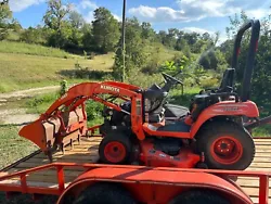 Kubota bx24 tractor. The hood and screen are missing.